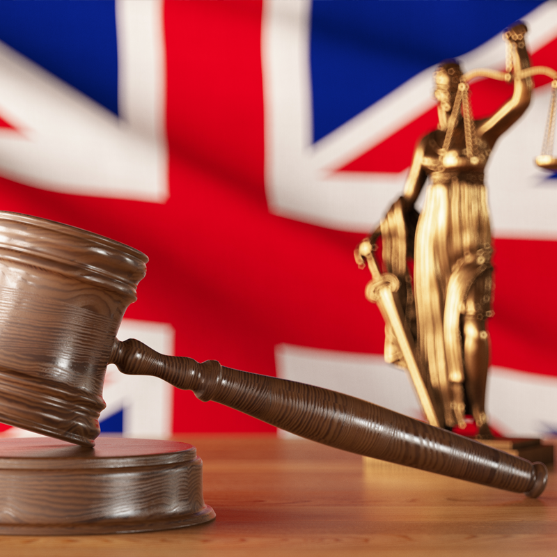 Legal symbols in front of the UK Union flag