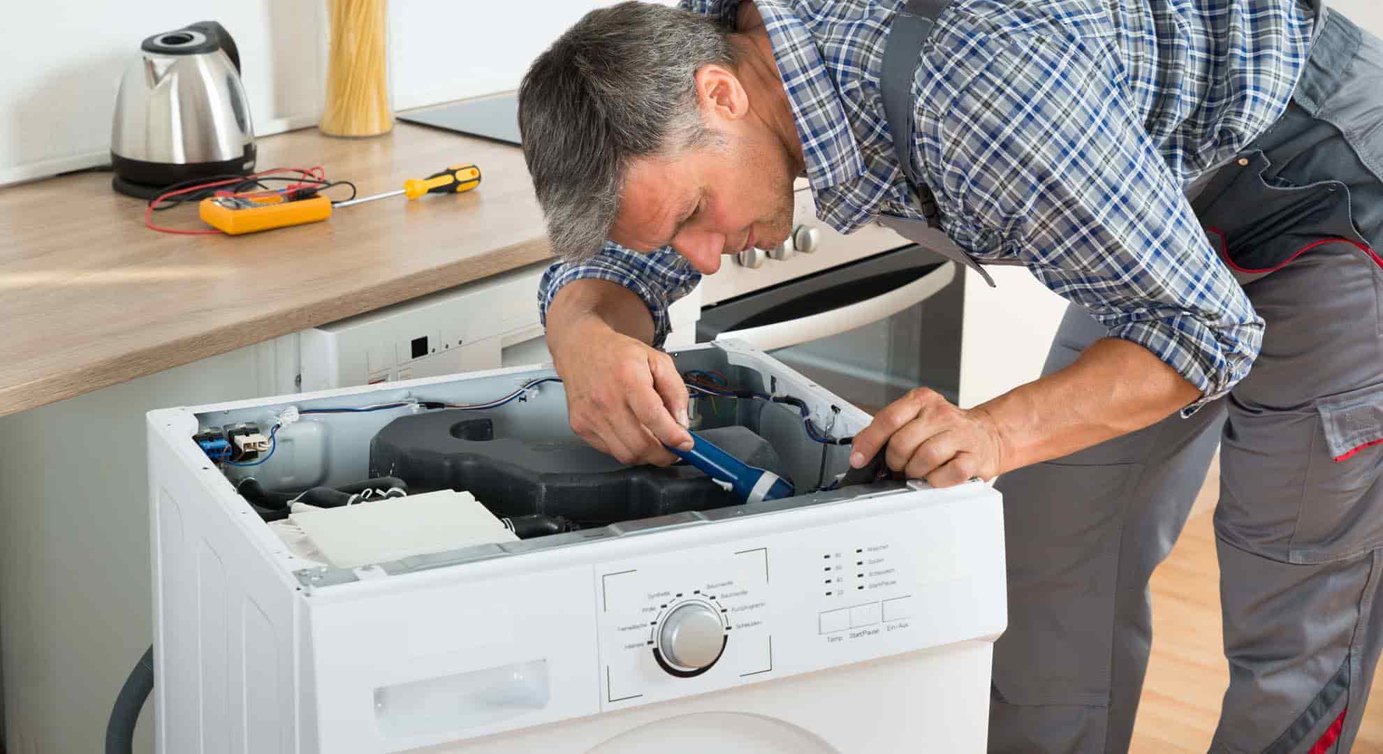 Person repairing a washing machine