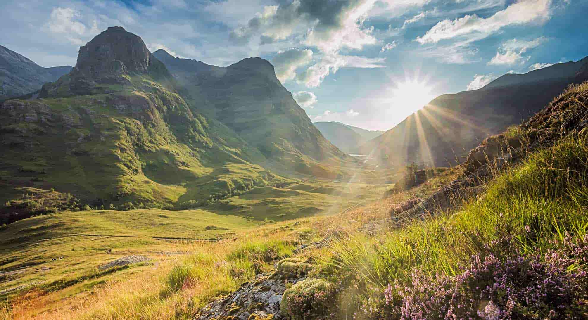 Photo of Glencoe with the sun above the mountains - how is Scotland's carbon footprint changing