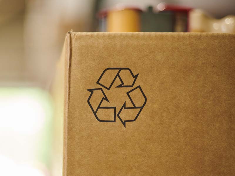Photo of a cardboard box displaying the mobius loop recycling symbol
