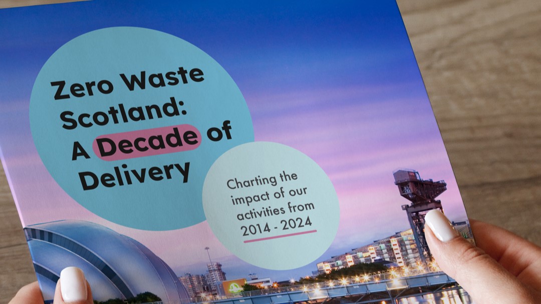 Someone holding a printed copy of a report titled 'Zero Waste Scotland: A Decade of Delivery'