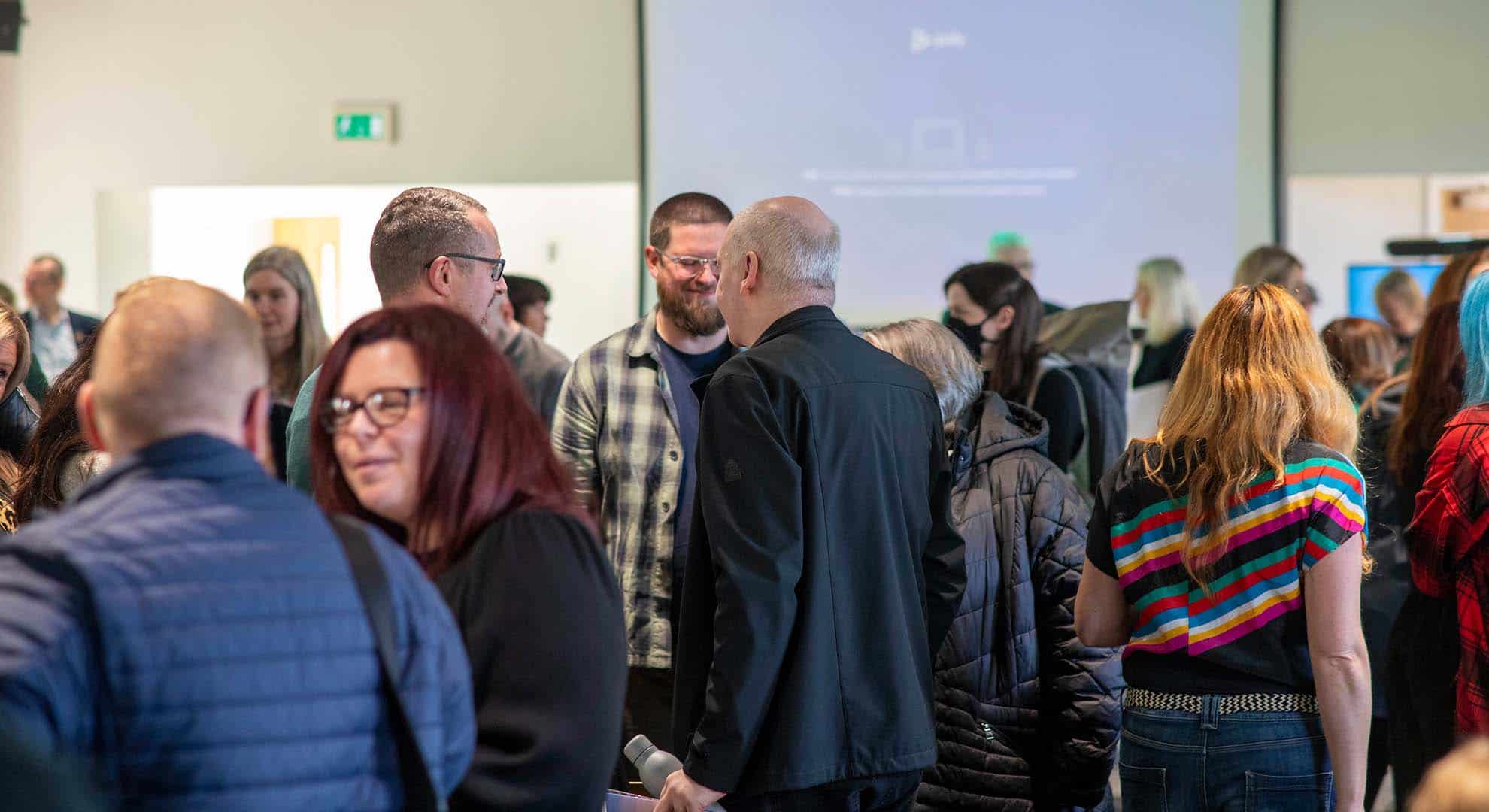 Photo of Zero Waste Scotland colleagues chatting after an All Colleague Update